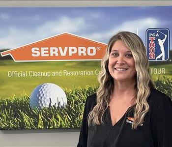 A female SERVPRO employee is shown in a light blue shirt