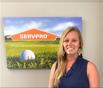Female SERVPRO employee Angel White is shown standing in front of a sign