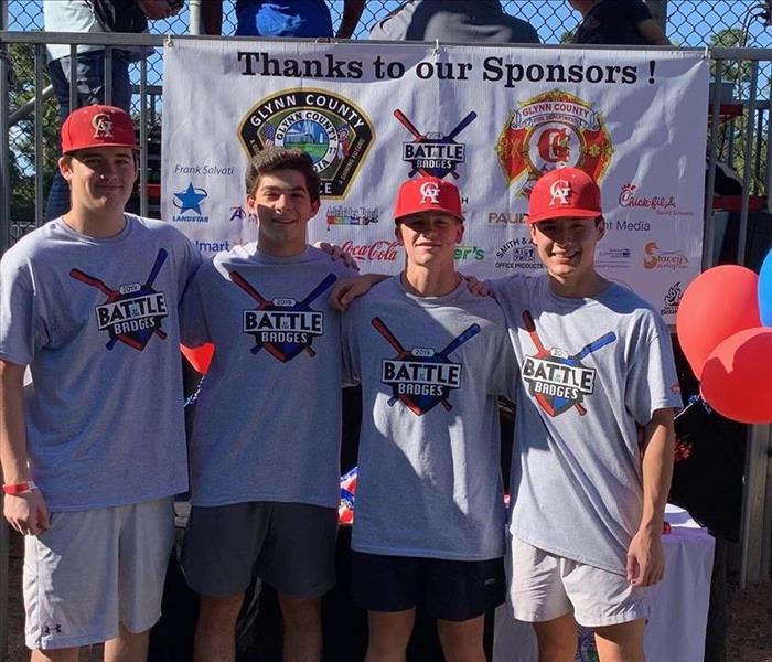 4 Glynn Academy Baseball players helping out at the Battle of the Badges game!