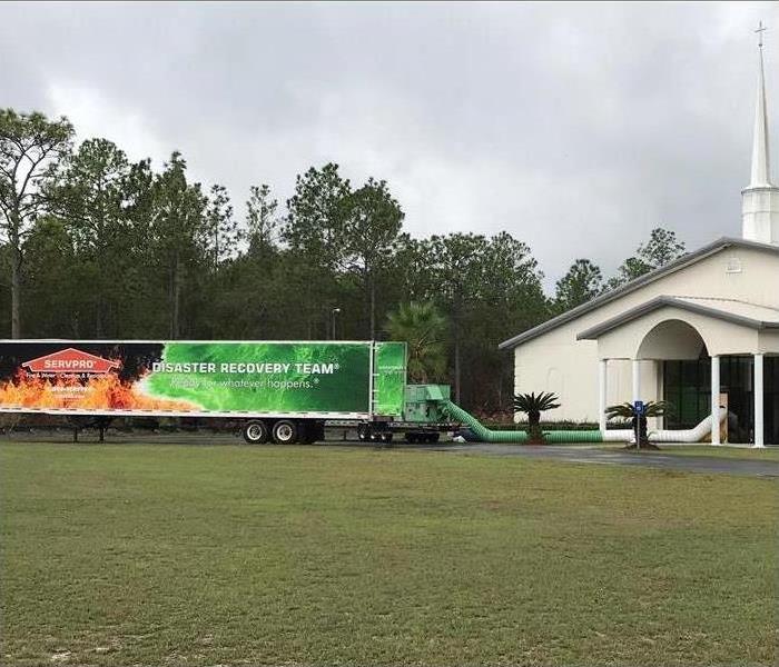 Church with SERVPRO trucks parked outside.